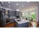Modern kitchen boasts stainless steel appliances, gray cabinets, and a center island with a white countertop at 2637 Morningside Nw Trl, Kennesaw, GA 30144