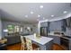 Open-concept kitchen with gray cabinets, stainless steel appliances, and a view into the living area at 2637 Morningside Nw Trl, Kennesaw, GA 30144