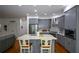 Open-concept kitchen with gray cabinets, stainless steel appliances, and a view into the living area at 2637 Morningside Nw Trl, Kennesaw, GA 30144