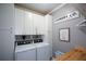 Well-organized laundry room with ample cabinet space, modern washer/dryer, and stylish decor at 2637 Morningside Nw Trl, Kennesaw, GA 30144