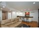 Open living area with hardwood floors, bar area and a comfortable lounge sofa at 2637 Morningside Nw Trl, Kennesaw, GA 30144