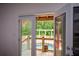 View from the door to a wooden patio and swimming pool surrounded by lush trees at 2637 Morningside Nw Trl, Kennesaw, GA 30144