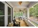Enclosed porch with wood flooring, ceiling fans and outdoor seating with screened windows at 2637 Morningside Nw Trl, Kennesaw, GA 30144