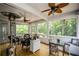 Cozy screened-in porch with ceiling fans, wood flooring and windows providing natural light and outdoor views at 2637 Morningside Nw Trl, Kennesaw, GA 30144