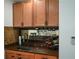 Wet bar with upper cabinets, granite counters, sink, backsplash and wine rack at 2637 Morningside Nw Trl, Kennesaw, GA 30144