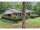 Brick home side view, showcasing lush landscaping and a winding walkway to the front entrance at 286 Hilton Way Way, Canton, GA 30114