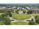 Aerial view of a picturesque community town center, showcasing the green space, city hall, and surrounding businesses at 3743 Lake Edge Dr, Suwanee, GA 30024