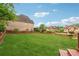 Spacious backyard featuring a lush lawn and wooden fence at 3743 Lake Edge Dr, Suwanee, GA 30024