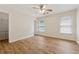 Bright bedroom with wood-look floors, ceiling fan, and natural light from two windows at 3743 Lake Edge Dr, Suwanee, GA 30024