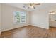 Comfortable bedroom featuring wood-look floors and a large window with natural light at 3743 Lake Edge Dr, Suwanee, GA 30024
