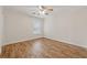 Clean bedroom with wood-look floors, neutral walls, ceiling fan, and a bright window at 3743 Lake Edge Dr, Suwanee, GA 30024