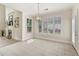 Open dining room with large windows, tiled floor, modern light fixture, and bright, neutral paint at 3743 Lake Edge Dr, Suwanee, GA 30024