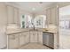 Bright kitchen featuring white cabinetry, granite countertops, stainless steel dishwasher, and arched window accents at 3743 Lake Edge Dr, Suwanee, GA 30024