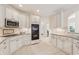 Kitchen with granite countertops, stainless appliances, and white cabinetry at 3743 Lake Edge Dr, Suwanee, GA 30024