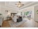 Main bedroom with tray ceiling, wood floors, and sitting area at 3743 Lake Edge Dr, Suwanee, GA 30024