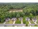 Aerial view of homes near a tree-lined lake with lush greenery and neighborhood streets at 605 Pebble Blvd, Covington, GA 30016