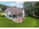 Backyard of a home with a screened in porch, patio, green grass and wooded view at 605 Pebble Blvd, Covington, GA 30016