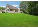 Sprawling backyard with lush lawn and mature trees at 605 Pebble Blvd, Covington, GA 30016