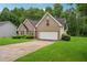Charming brick home with a well-manicured lawn and two-car garage at 605 Pebble Blvd, Covington, GA 30016