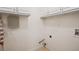 Utility laundry room with overhead cabinets, and hookups for a washer and dryer at 605 Pebble Blvd, Covington, GA 30016