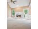 Bright living room with a fireplace, vaulted ceiling, and an exit to the yard at 605 Pebble Blvd, Covington, GA 30016