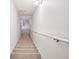 Carpeted stairway with a handrail, providing safe and comfortable access between floors in the home at 605 Pebble Blvd, Covington, GA 30016