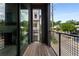 Balcony featuring wood flooring and a black metal railing with neighborhood views at 2347 Hosea L Williams Ne Dr # 11, Atlanta, GA 30317