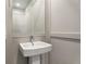 Bathroom featuring a pedestal sink, modern faucet, and a large framed mirror at 2347 Hosea L Williams Ne Dr # 11, Atlanta, GA 30317