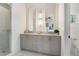 Modern bathroom features a glass shower and double sink vanity with two arched mirrors at 2347 Hosea L Williams Ne Dr # 11, Atlanta, GA 30317