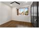 Bright bedroom with dark hardwood floors, modern ceiling fan and large window at 2347 Hosea L Williams Ne Dr # 11, Atlanta, GA 30317