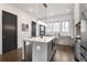 Spacious kitchen features an island, modern appliances, gray cabinets, and hardwood floors at 2347 Hosea L Williams Ne Dr # 11, Atlanta, GA 30317