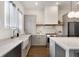 Bright kitchen features gray cabinets, stainless steel appliances, an island, and hardwood floors at 2347 Hosea L Williams Ne Dr # 11, Atlanta, GA 30317