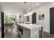 Open floor plan kitchen featuring a white island, stainless steel appliances, and hardwood floors at 2347 Hosea L Williams Ne Dr # 11, Atlanta, GA 30317