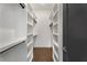 Bright walk-in closet featuring white shelving units and hardwood flooring at 2347 Hosea L Williams Ne Dr # 11, Atlanta, GA 30317