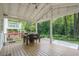 Spacious back porch with dining area, hot tub, and a view of lush greenery at 3012 Dempsey Pl, Lawrenceville, GA 30044