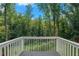 Scenic backyard view with a white fence and dense trees at 3012 Dempsey Pl, Lawrenceville, GA 30044
