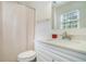 Well-lit bathroom with modern vanity, toilet, and shower at 3012 Dempsey Pl, Lawrenceville, GA 30044