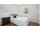 Comfortable bedroom features hardwood floors and a large window for natural light at 3012 Dempsey Pl, Lawrenceville, GA 30044