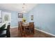 The dining room offers a table with chairs, hardwood floors, and access to the kitchen at 3012 Dempsey Pl, Lawrenceville, GA 30044