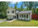 Inviting exterior of a well-maintained home showcasing a classic design amidst a backdrop of mature trees at 3012 Dempsey Pl, Lawrenceville, GA 30044