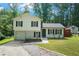 Charming home featuring a blend of traditional and modern design with lush greenery surrounding the property at 3012 Dempsey Pl, Lawrenceville, GA 30044