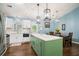 Bright kitchen features a center island with seating, stainless appliances, and updated finishes at 3012 Dempsey Pl, Lawrenceville, GA 30044