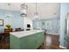 Spacious kitchen with island, modern light fixtures and stainless steel appliances at 3012 Dempsey Pl, Lawrenceville, GA 30044