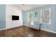 Cozy living room bathed in natural light, featuring hardwood floors and minimalist decor at 3012 Dempsey Pl, Lawrenceville, GA 30044