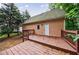 Back deck with railings, exterior door and view of yard surrounded by trees at 3135 Washington Rd, Atlanta, GA 30344