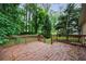 Wooden back deck with brown railings offering a view of a lush wooded area at 3135 Washington Rd, Atlanta, GA 30344