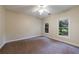 Spacious bedroom featuring neutral walls, carpet, and windows offering views of the outside at 3135 Washington Rd, Atlanta, GA 30344