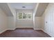 Bedroom with three windows, carpeting, neutral walls, and a closet at 3135 Washington Rd, Atlanta, GA 30344