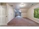 Large bedroom featuring neutral walls, carpet, and windows offering views of the outside at 3135 Washington Rd, Atlanta, GA 30344