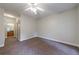 Bedroom showcases neutral walls and flooring and offers an open view of the hallway with the bathroom at the end at 3135 Washington Rd, Atlanta, GA 30344